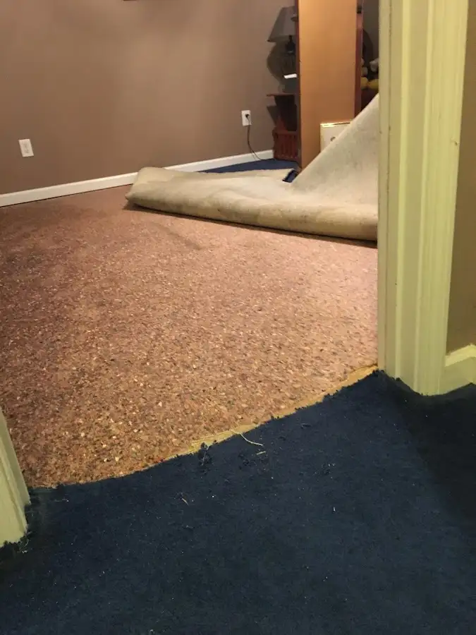 Carpet pad removal revealing water damage during Drying & Dehumidification in Santa Fe