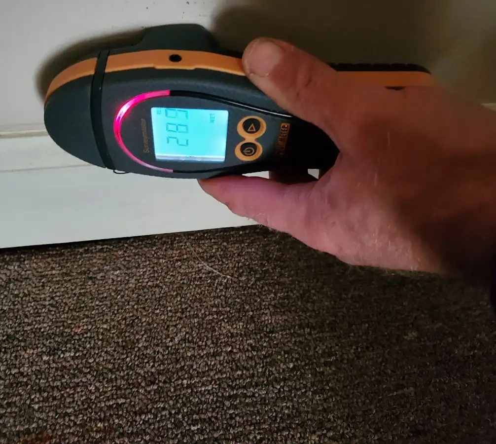 Moisture detection at baseboard during Storm Damage Restoration in Santa Fe